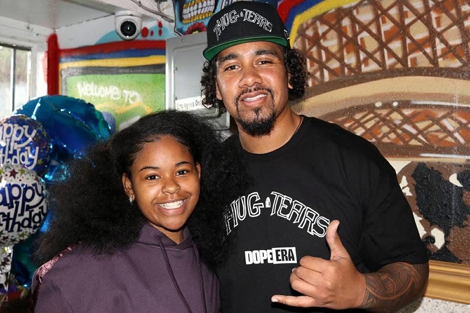 Dejah Vú smiling with a guest at a community event