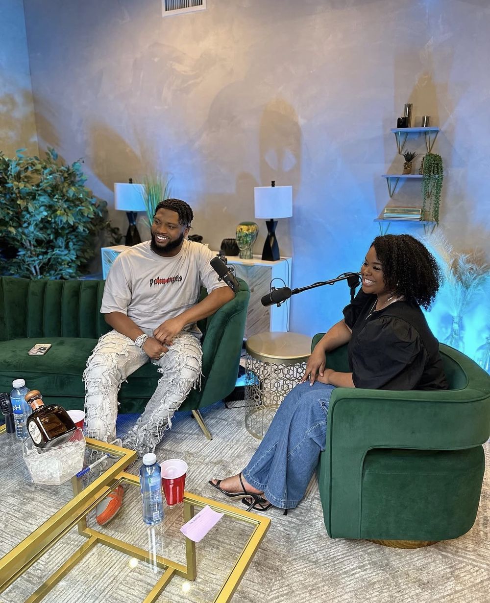 Dejah Vú interviewing Chef Dee on a podcast set with two microphones